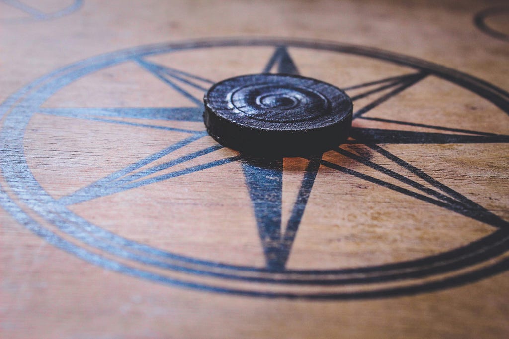 Carrom board with black carromman kept in the middle