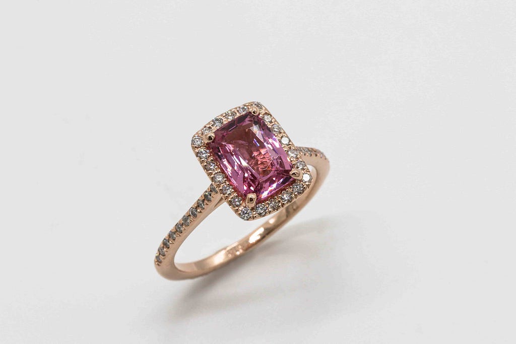 Close up picture of a pink sapphire diamond ring.