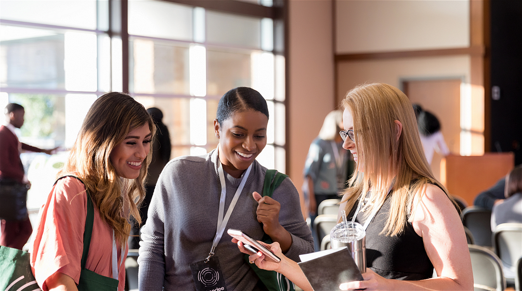 Three women cheerfully talking and networking