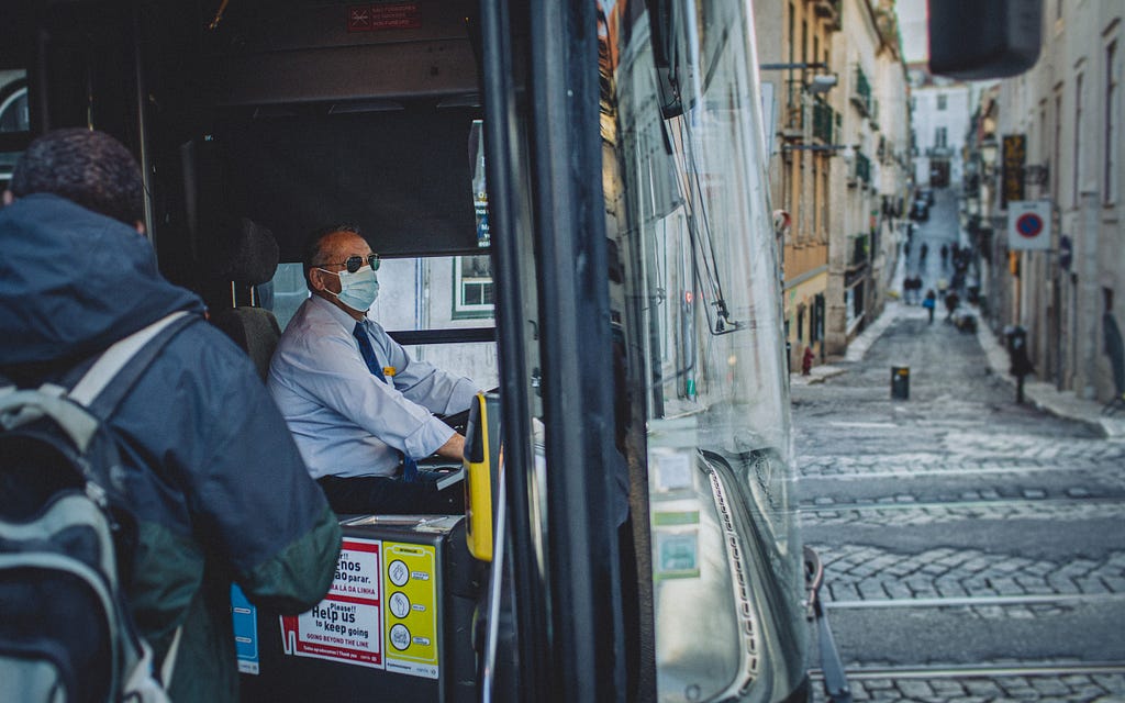 A bus driver with a surgical mask
