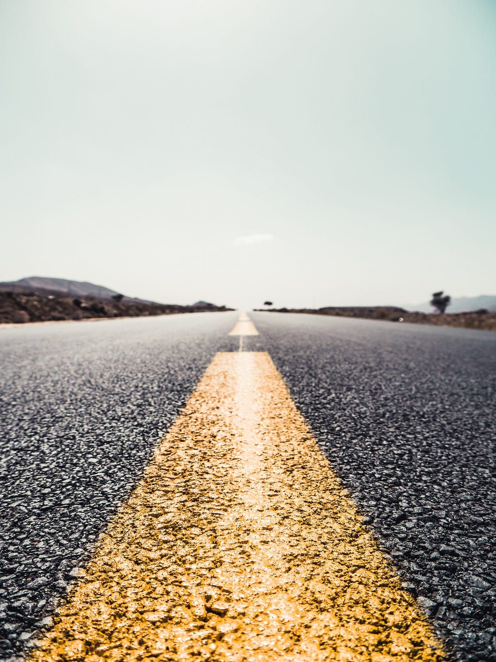 a highway with a lane separator in the middle of the image