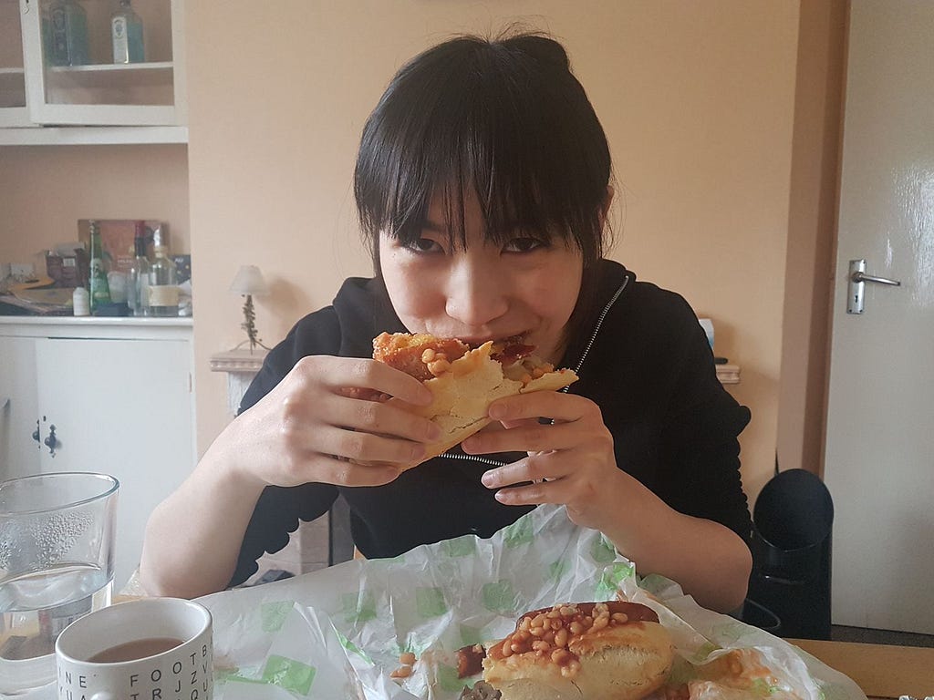 Rose attempting to consume an overstuffed breakfast roll