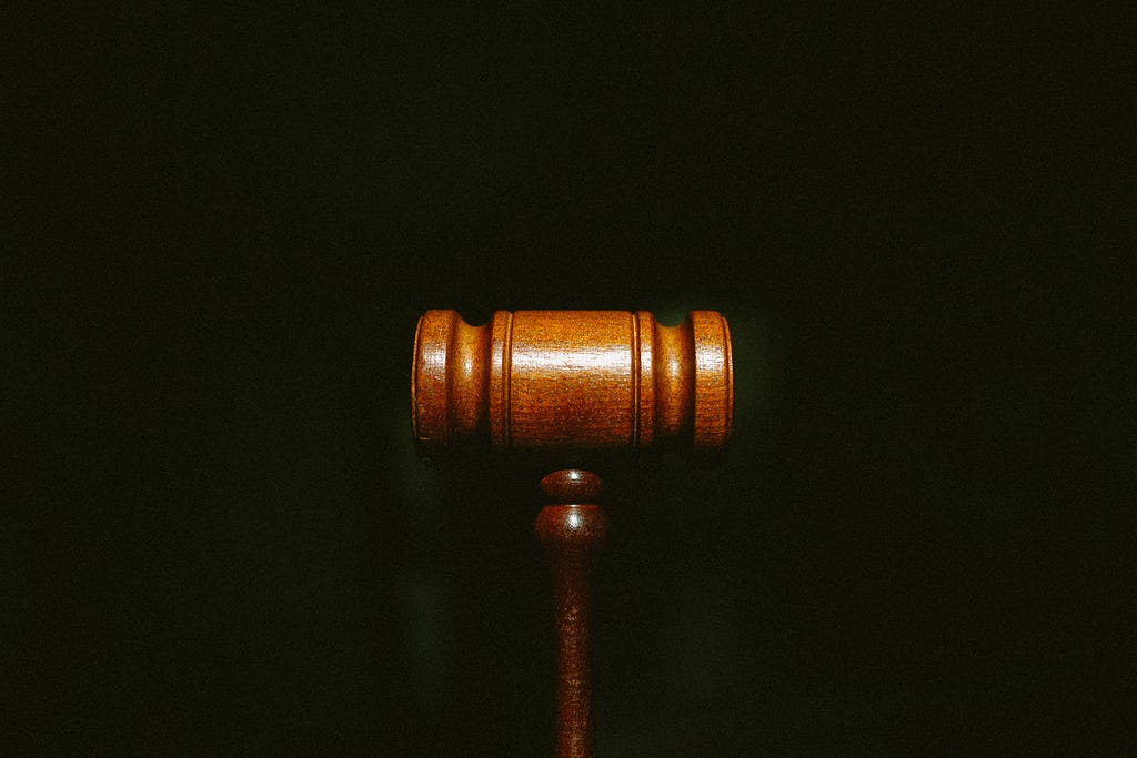 a wooden gavel with a black background