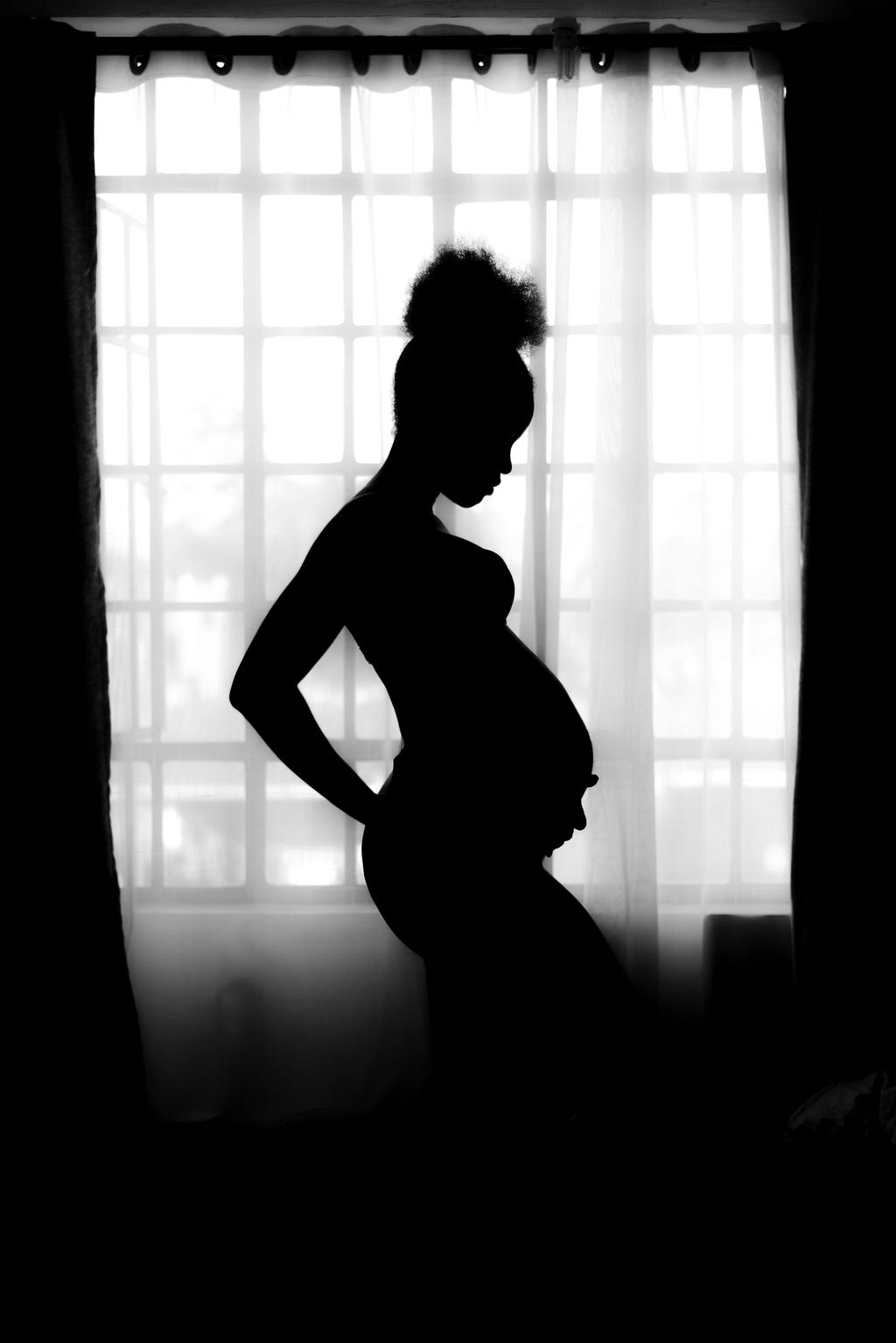 Pregnant woman in shadow