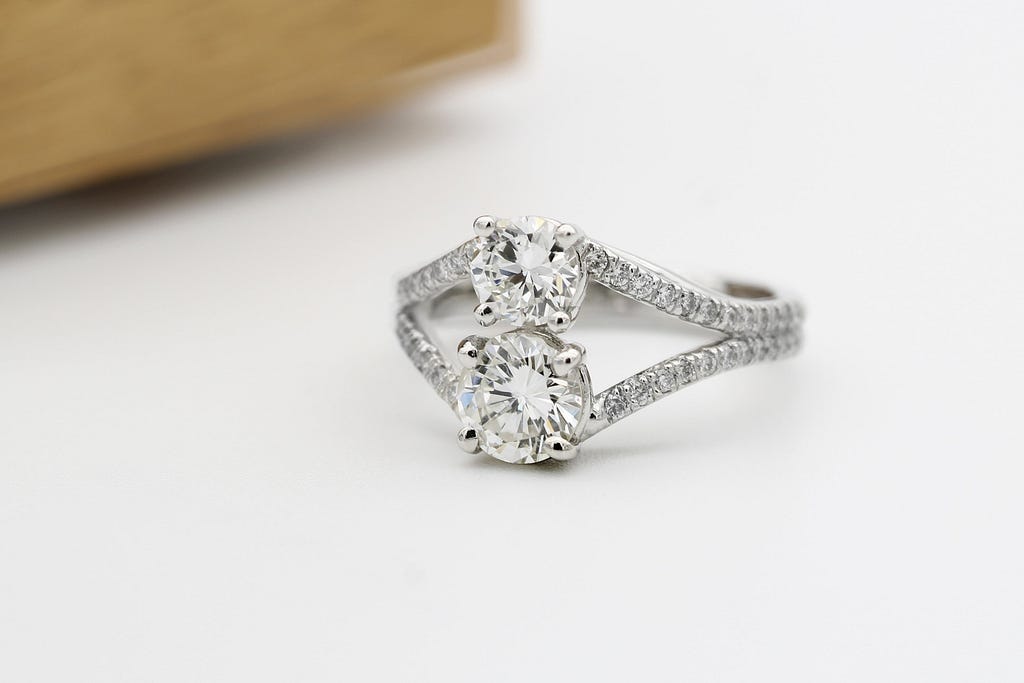 Two diamond engagement ring, set in a diamond band.