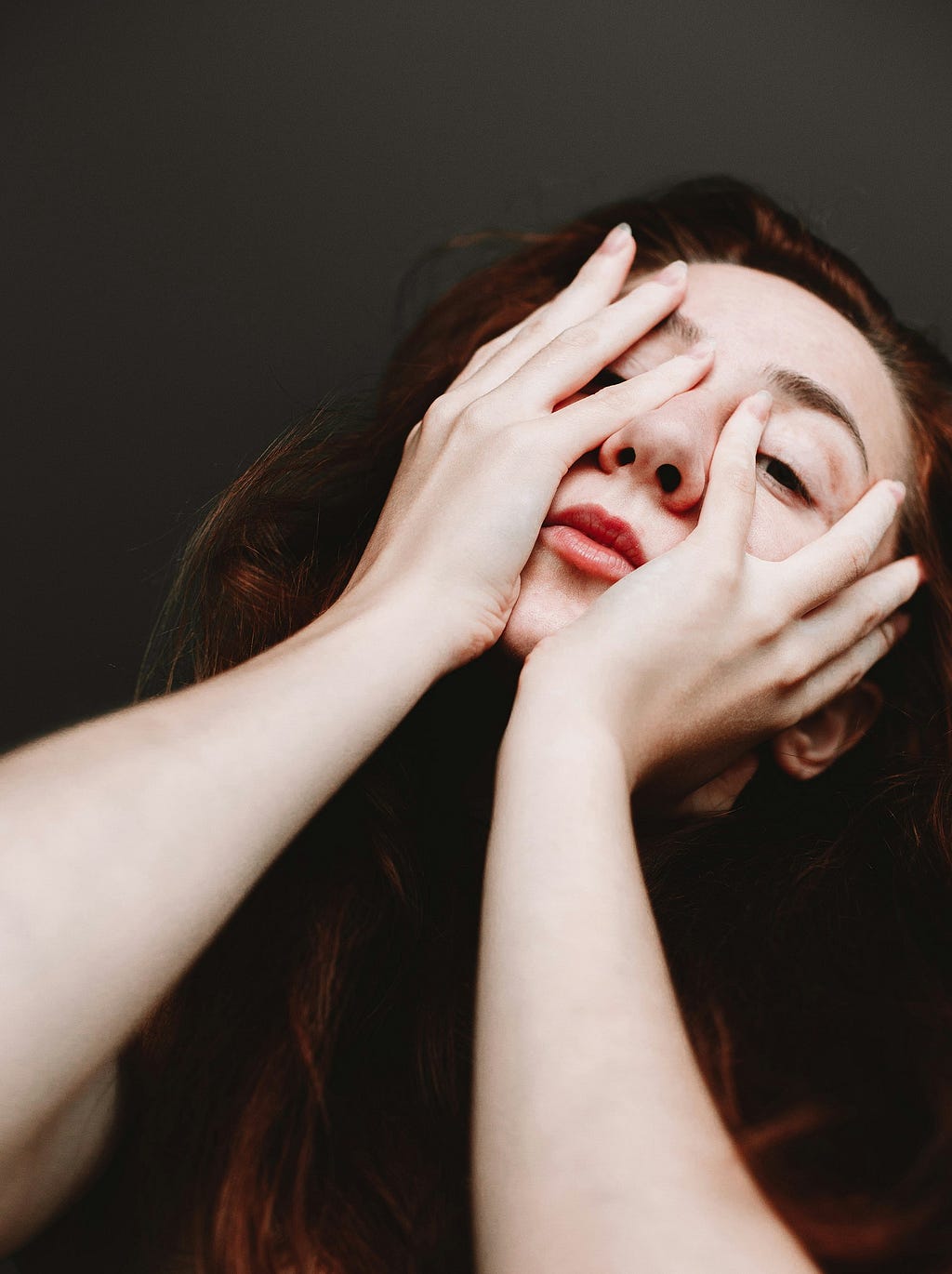 A woman with her face in her hands