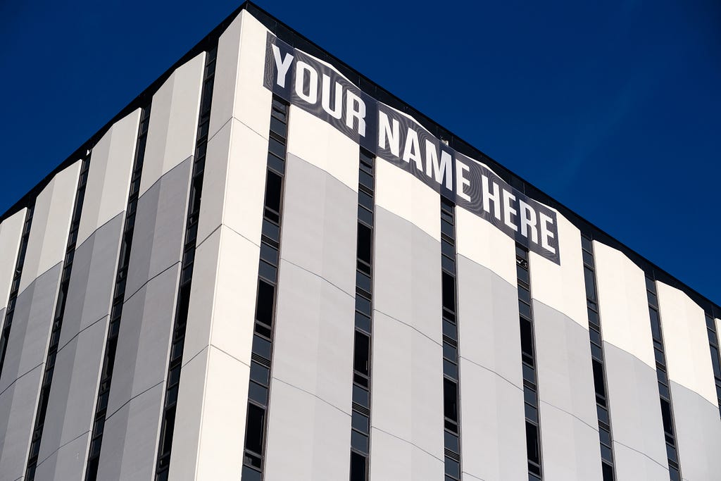 Building with banner that reads “YOUR NAME HERE”