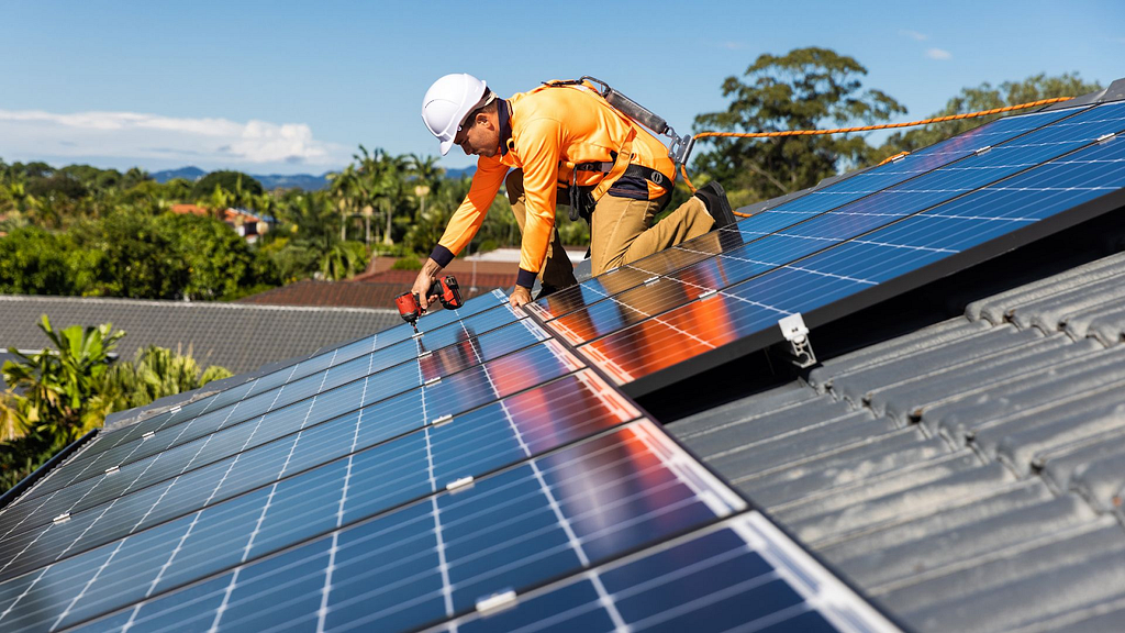installers install solar panels on the roof