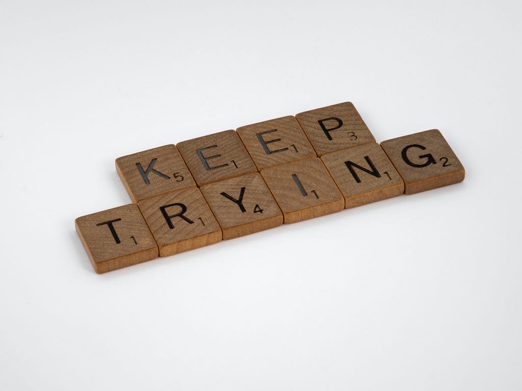 Scrabble tiles that spell “Keep trying”