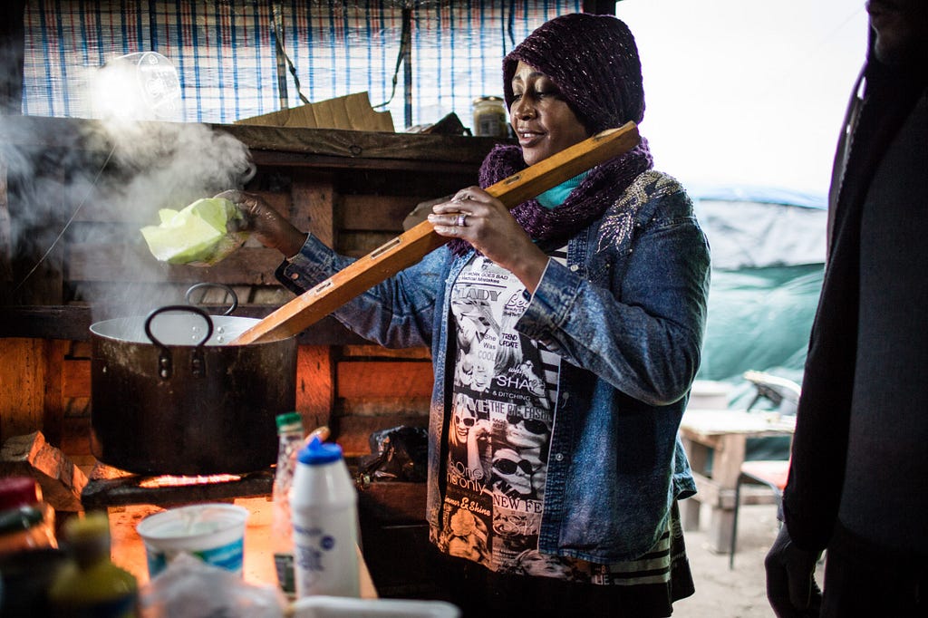 Rasha uses a piece of scrap wood to stir aseeda, a boiled flour porridge beloved by homesick Sudanese refugees.