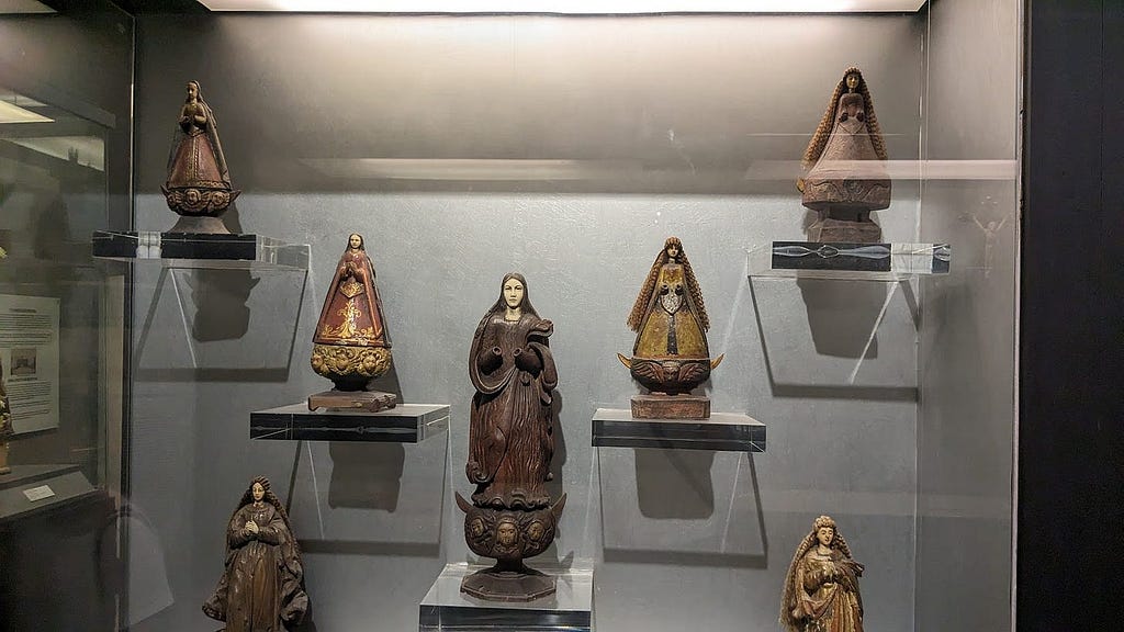 Various older statues of the Virgin Mary in a museum in Manila