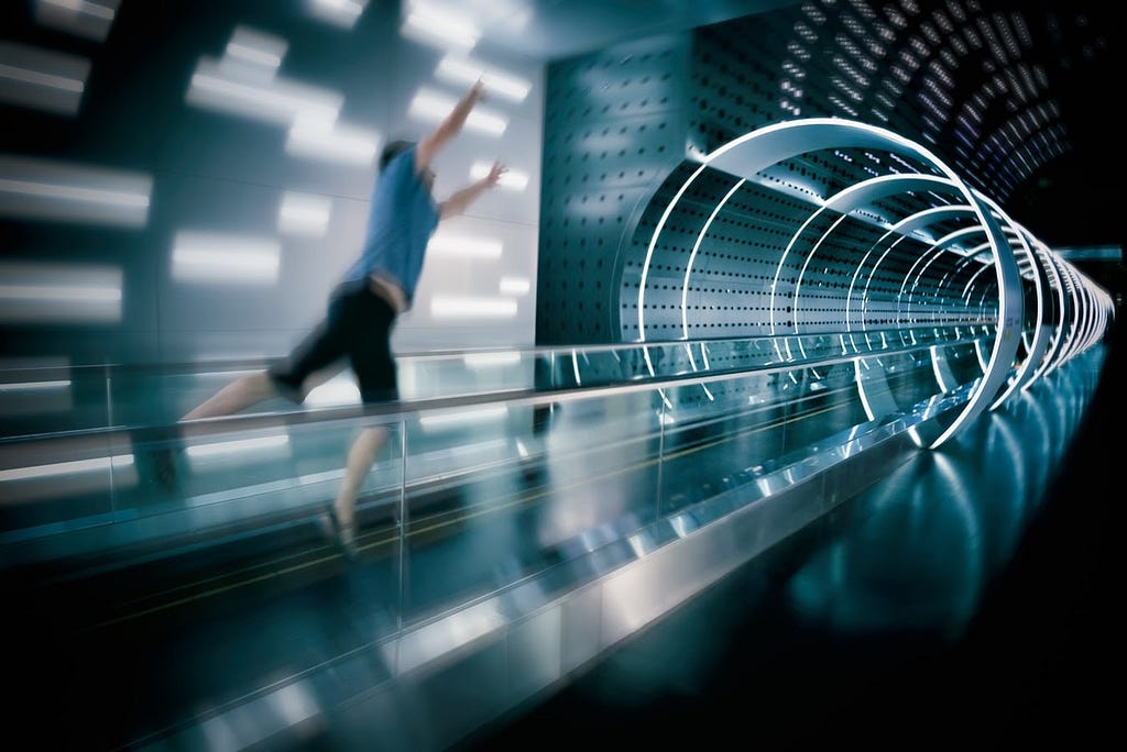 Man jumping on moving sidewalk