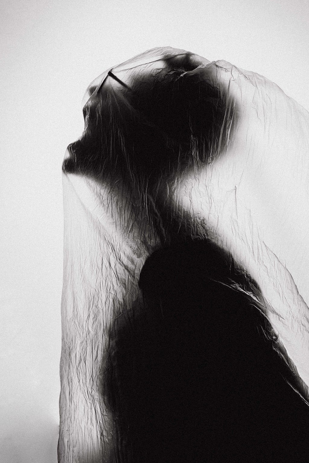 A woman struggles to breathe in a plastic bag.