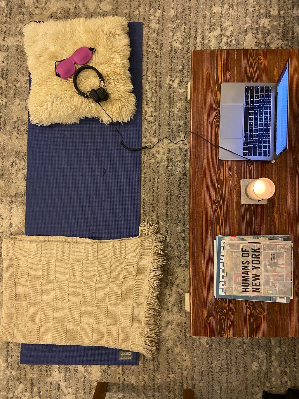 The author’s set up includes a yoga mat, her laptop, and a candle.