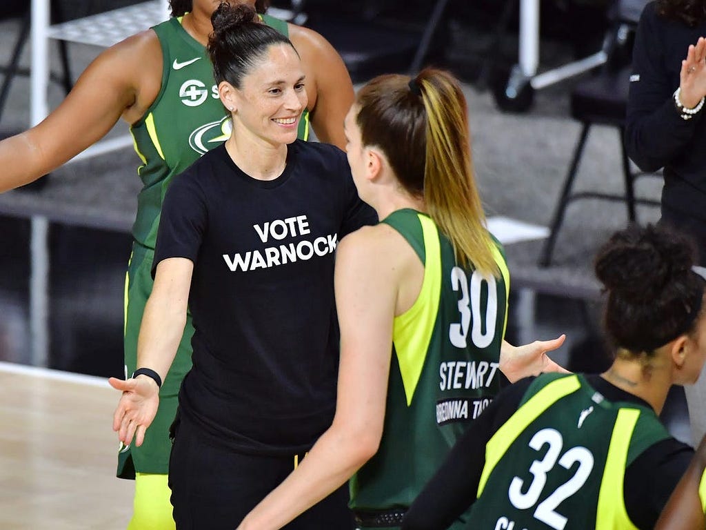 Sue Bird wears a “Vote Warnock” T-shirt during a 2020 Seattle Storm game.