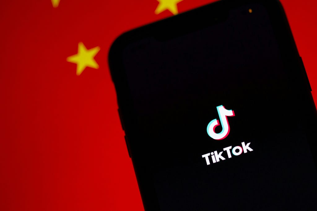 pic of the word “TikTok” with a red background- and yellow stars