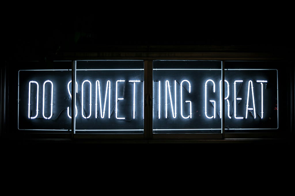 An image of the neon lights sighting a motivation phrase “do something great”