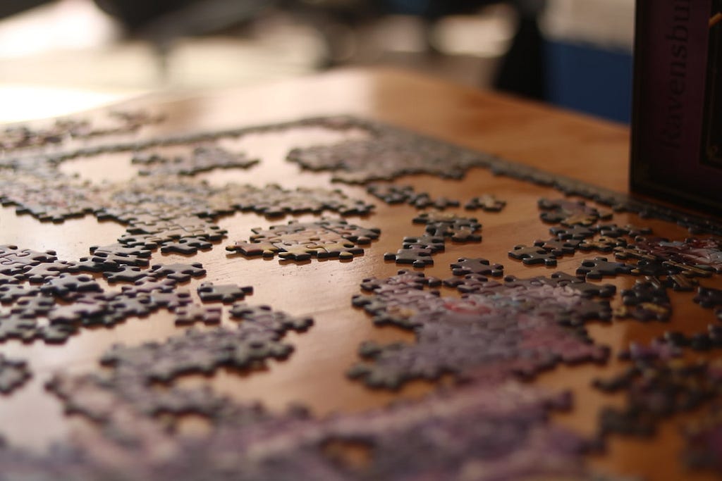 Incomplete puzzle on a wooden table