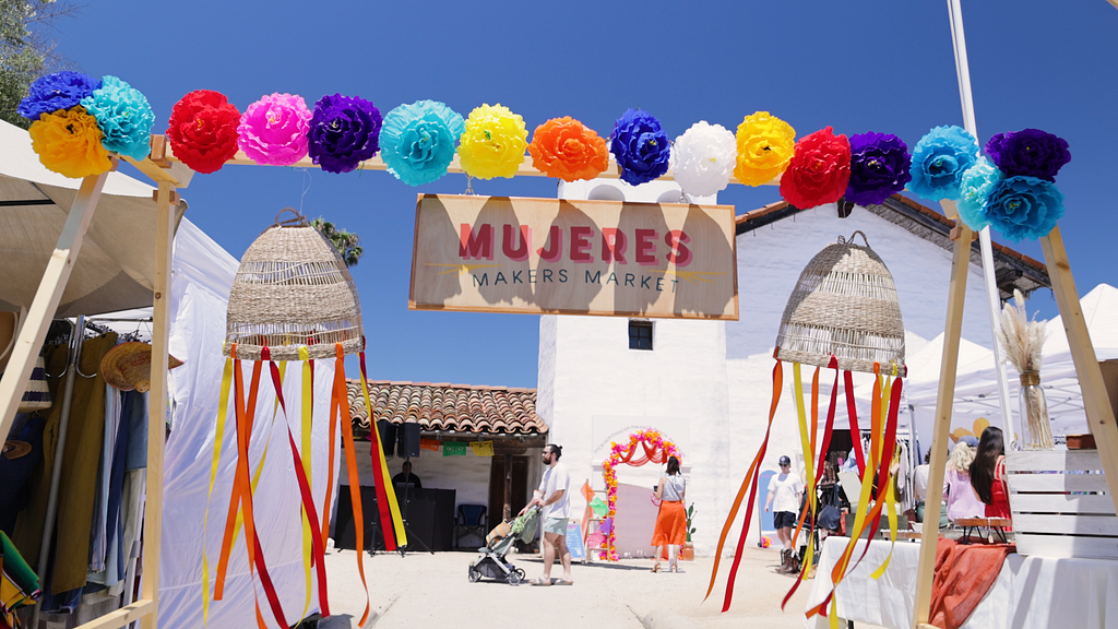 An image of the Mujeres Makers Market up above an archway for the market entrance.