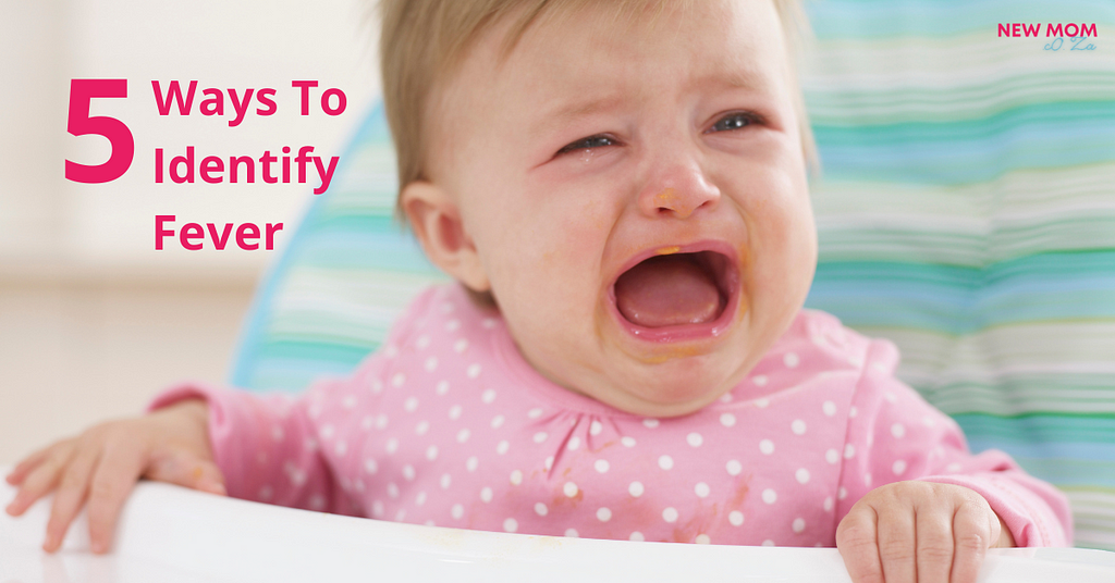 Baby in pink, crying. 5 ways to identify fever.