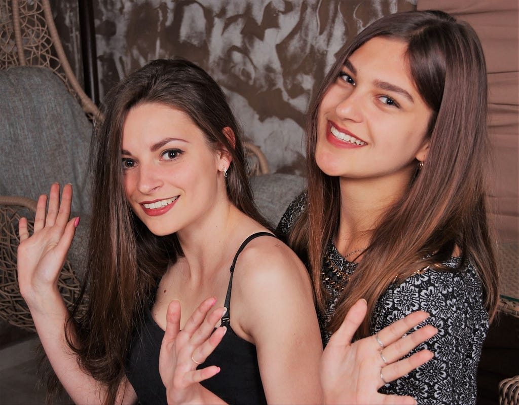 Two women doing jazz hands