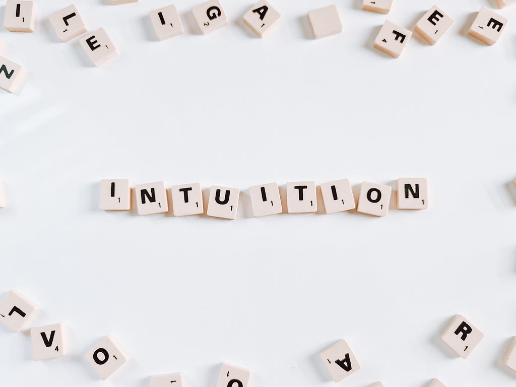 Scrabble tiles spell out “intuition.”