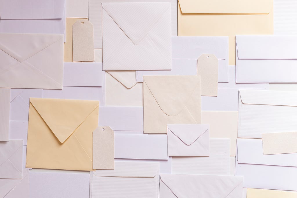 An array of different styles of envelopes arranged haphazardly.