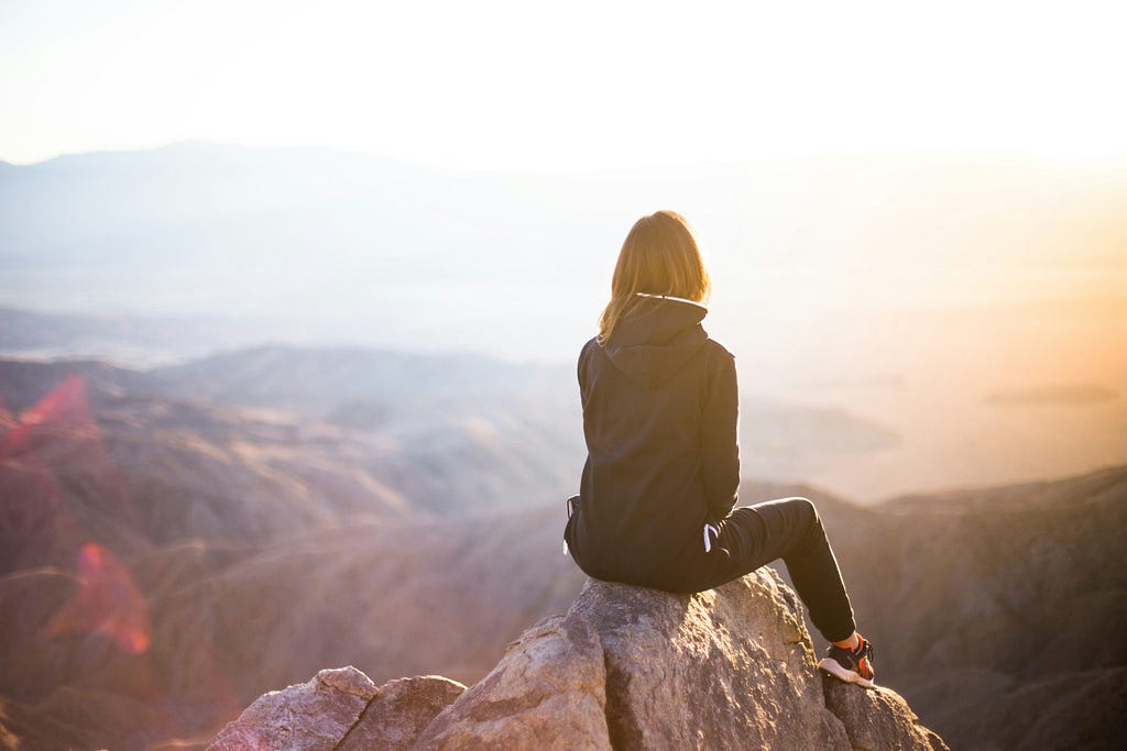 Girl enjoying view and relaxing alone in hilly areas