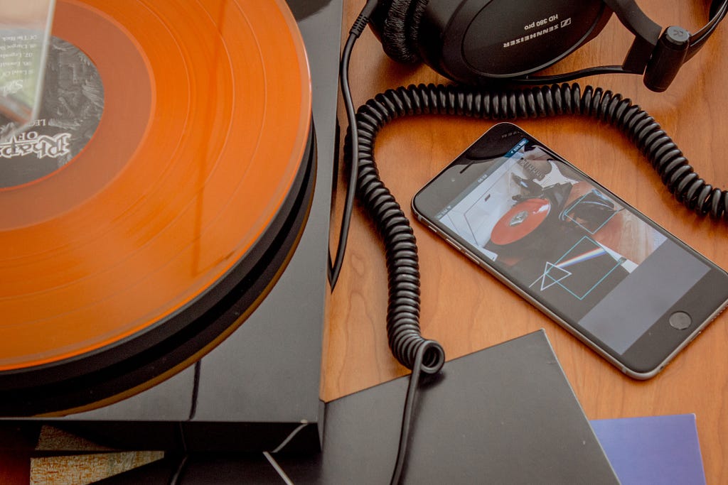 Vinyl record player, headphones, iPhone, records