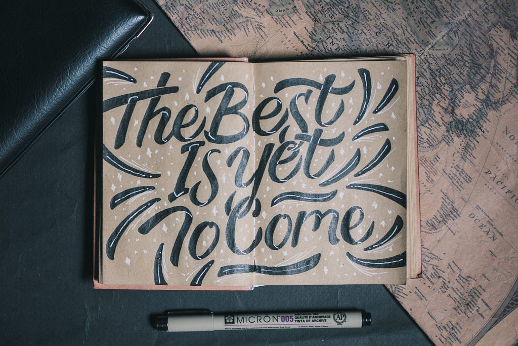 A book with “the best is yet to come” written on it