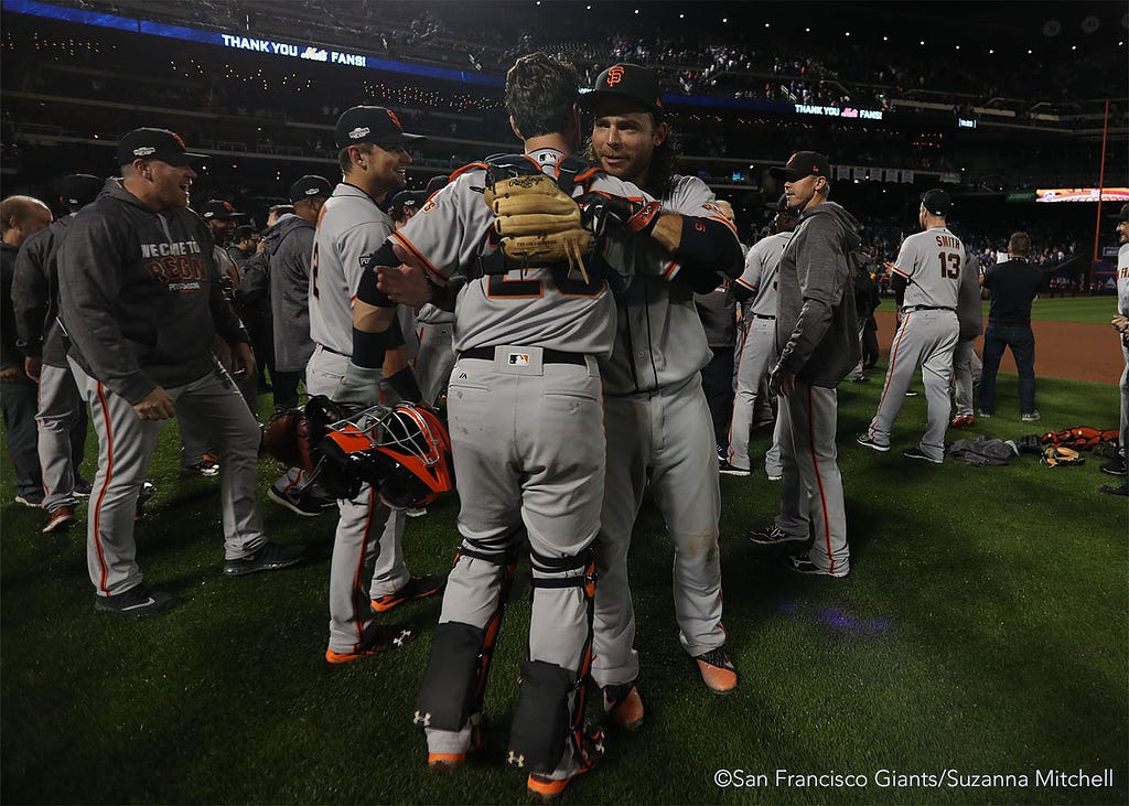 Buster Posey and Brandon Crawford celebrate after the end of the game.