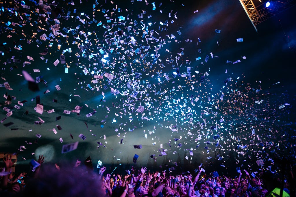 confetti shooting into the crowd at a music festival
