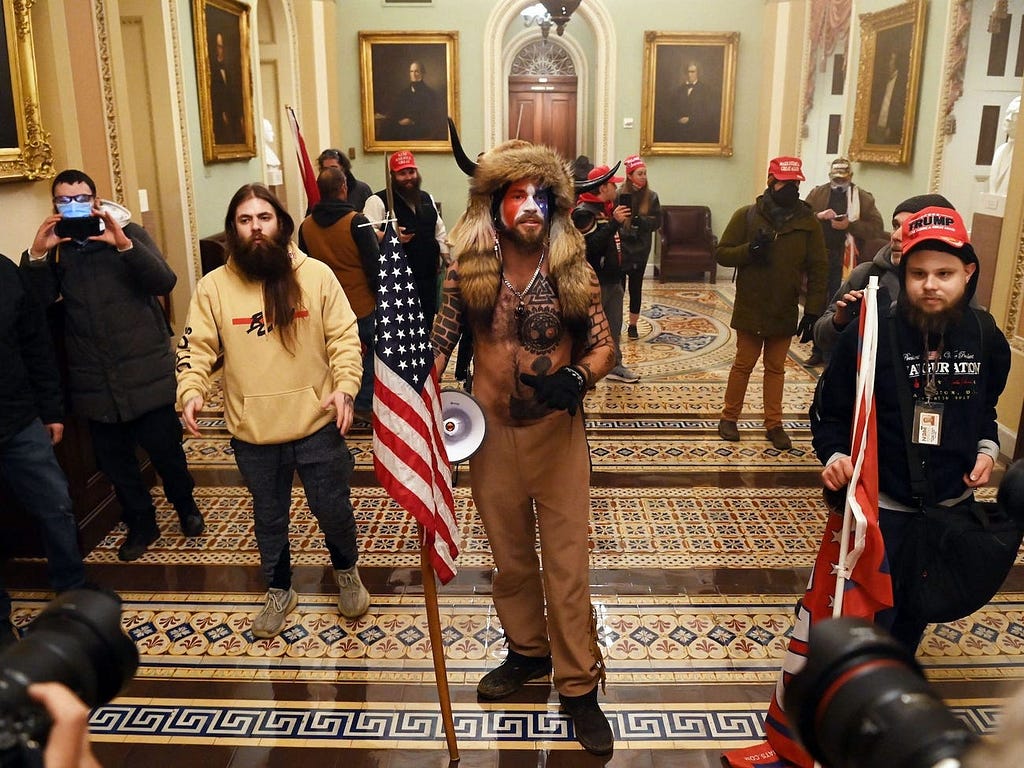 “QAnon Shaman” Jacob Anthony Chansley (center), pictured in the US Capitol on January 6, 2021.