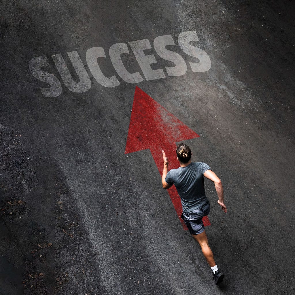 A runner running on the street toward a written sign called success with a red arrow pointing in that direction.