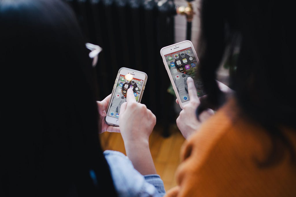 Women operating a smartphone to share a file