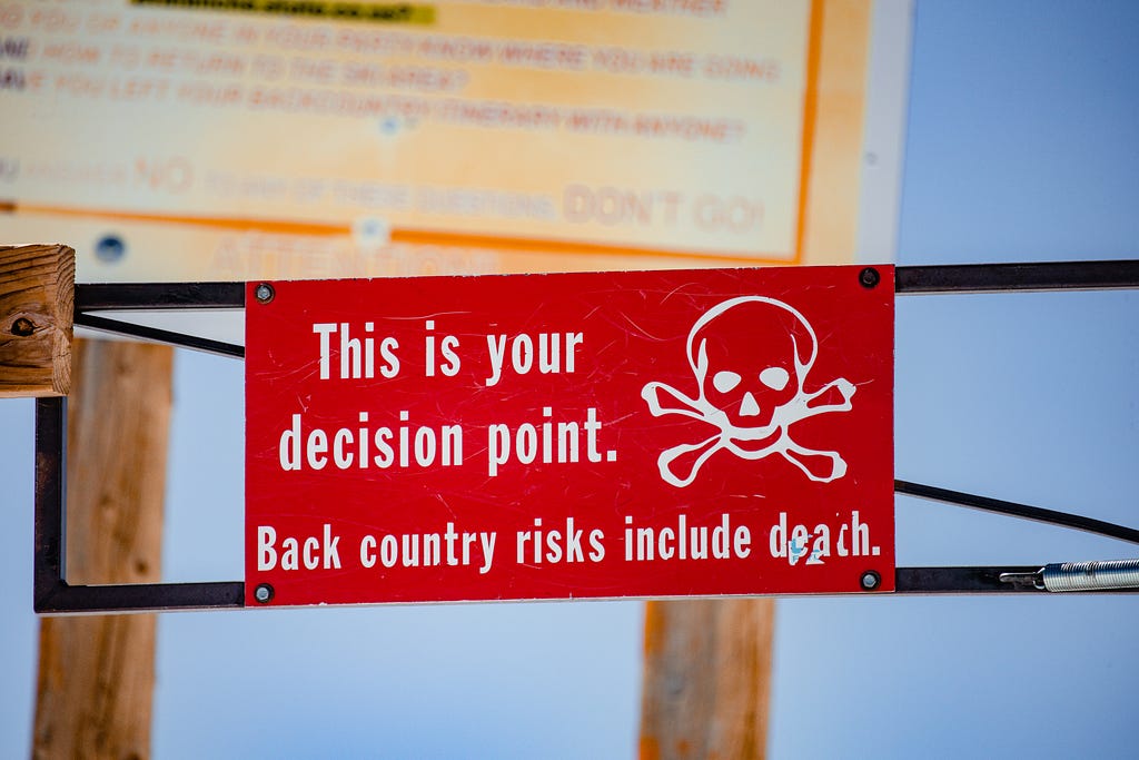 A sign posted at the entrance to rough back country, saying ‘this is your decision point’