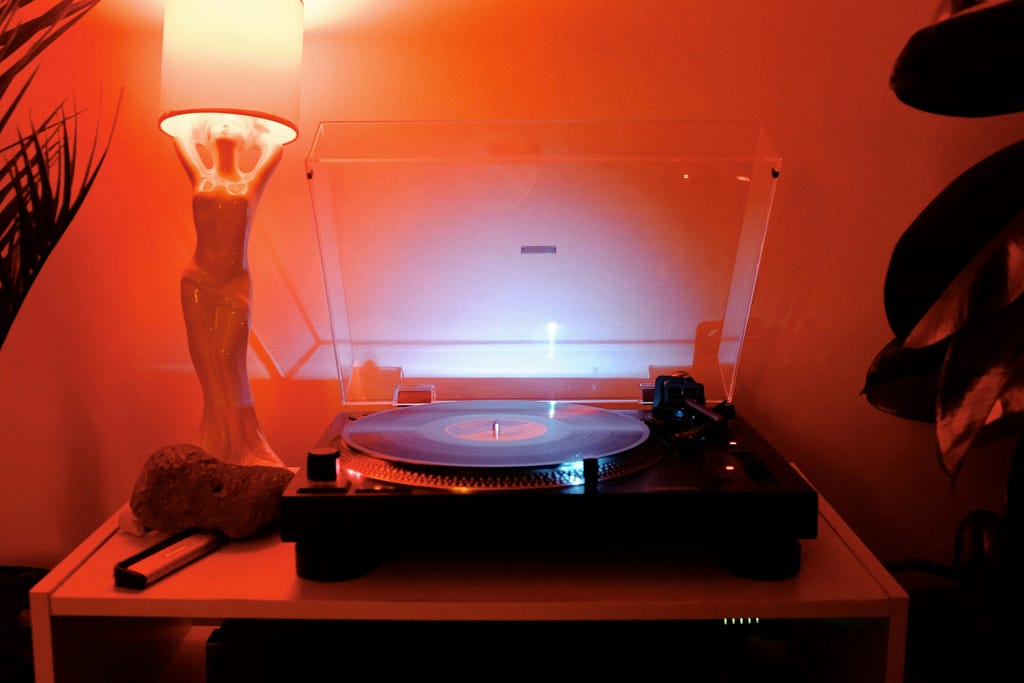 Atmospheric record player setup with moody red lighting