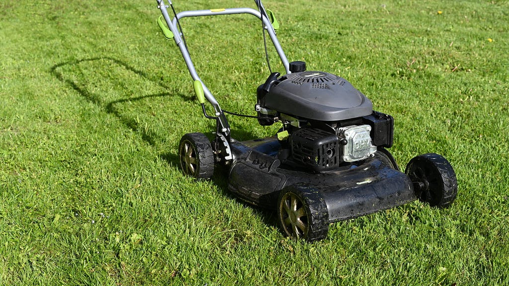 black lawn mower on green grass