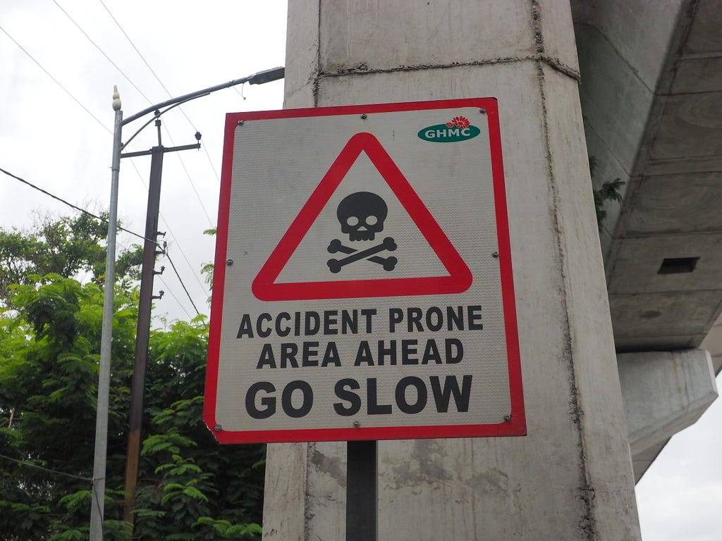 A signboard on the street that says “Accident prone area ahead. Go Slow”