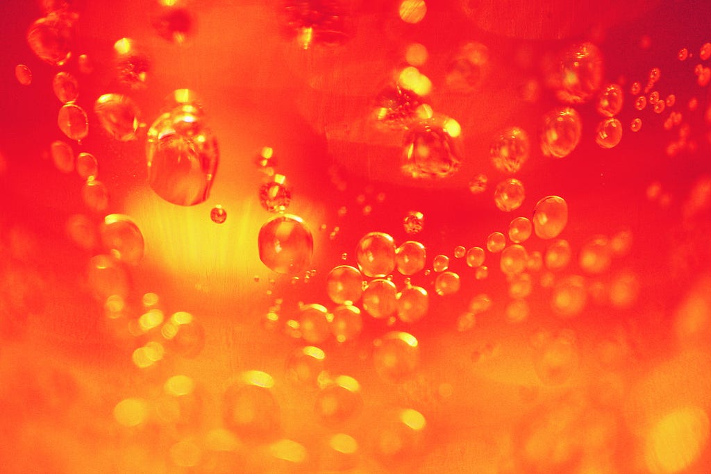 orange red, golden image of liquid with bubbles