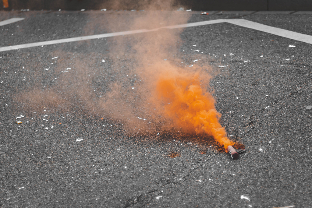 Photo of a colored smoke bomb by Sara Kurfeß on Unsplash