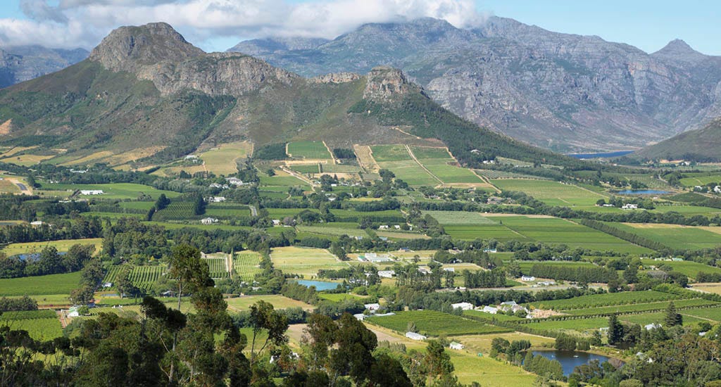 Landscape of plantation fields and mountains from Franschhoek Pass, South Africa