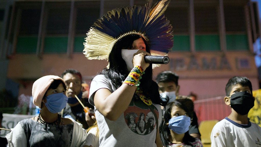 A climate activist holds a microphone among a crowd