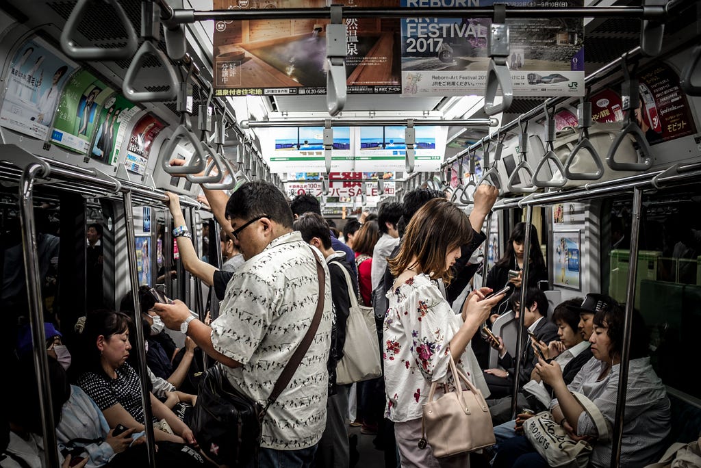 Subway travellers distracted by their smartphones.