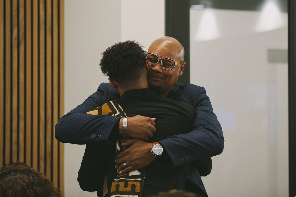 A heartfelt hug between Cayden Brown and his father after accepting the ‘Youth Justice Advocate Award’