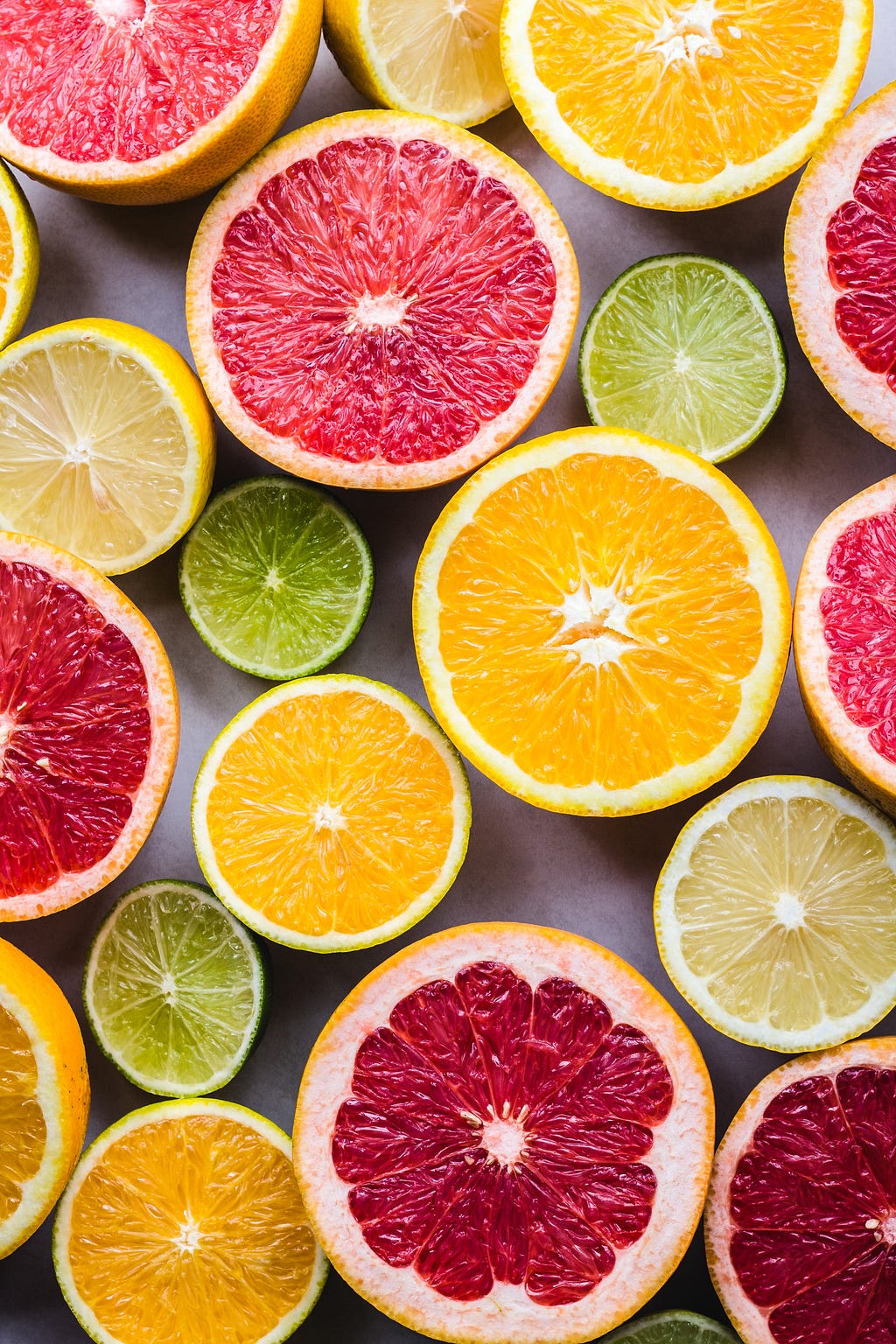 A colorful vertical photo of various citrus fruits