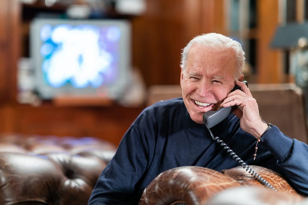 President Joe Biden talks on the phone with service members attending Super Bowl LV watch parties in Kabul and aboard the USS Nimitz on Feb. 7, 2021.