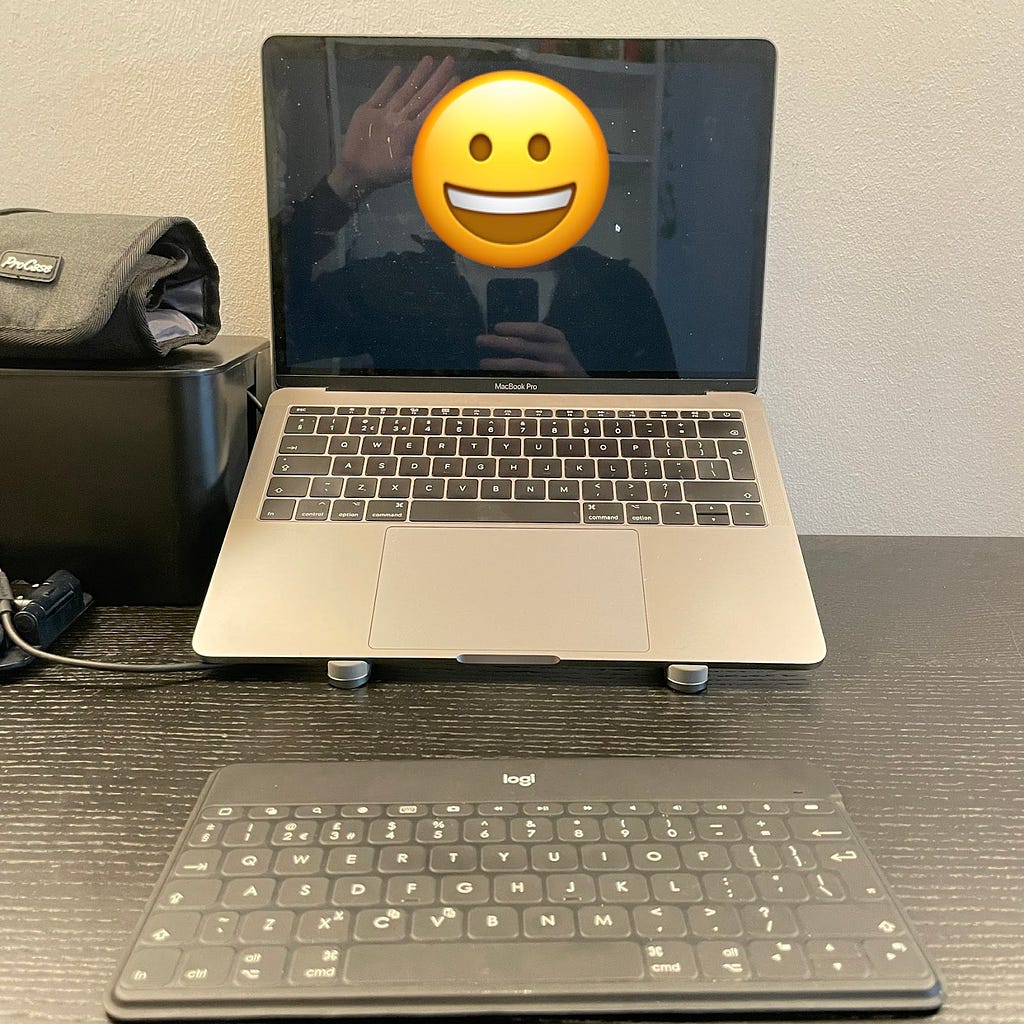 MacBook on a stand with external keyboard