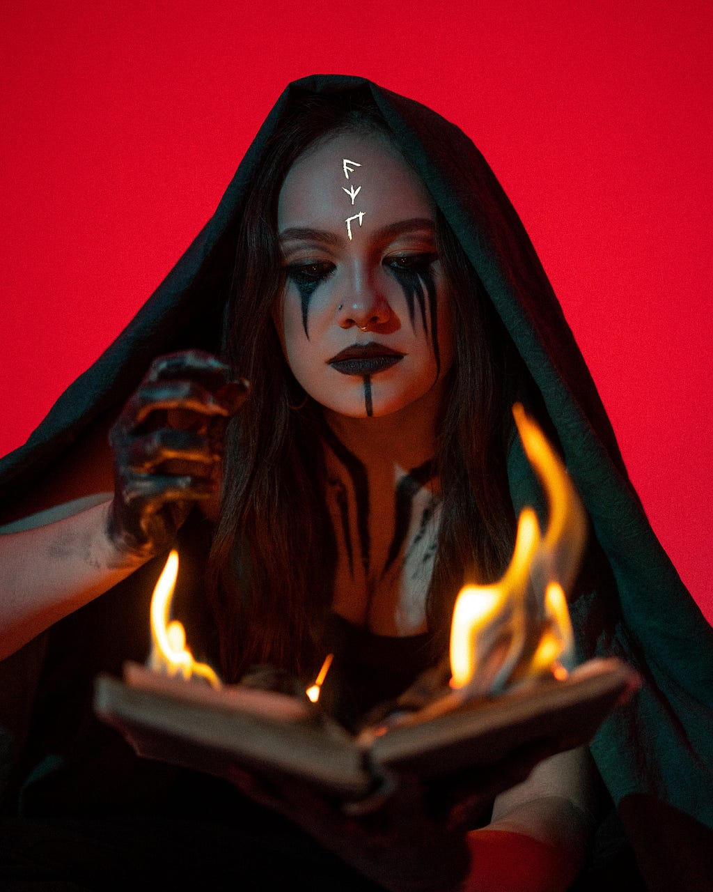 The photo depicts a woman before the fire, and black kohl kajal flowing from her eyes.
