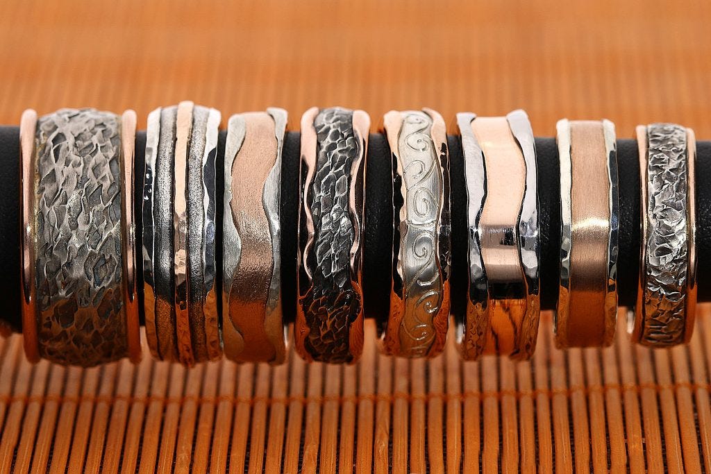 A group shot of eight wedding ring designs all hand-made by Mark Lloyd Master Goldsmith